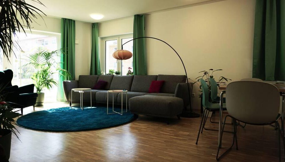 MGWH_Innen-scaled Innenansicht Gemeinschaftsraum des MGWH mit grossem Sofa